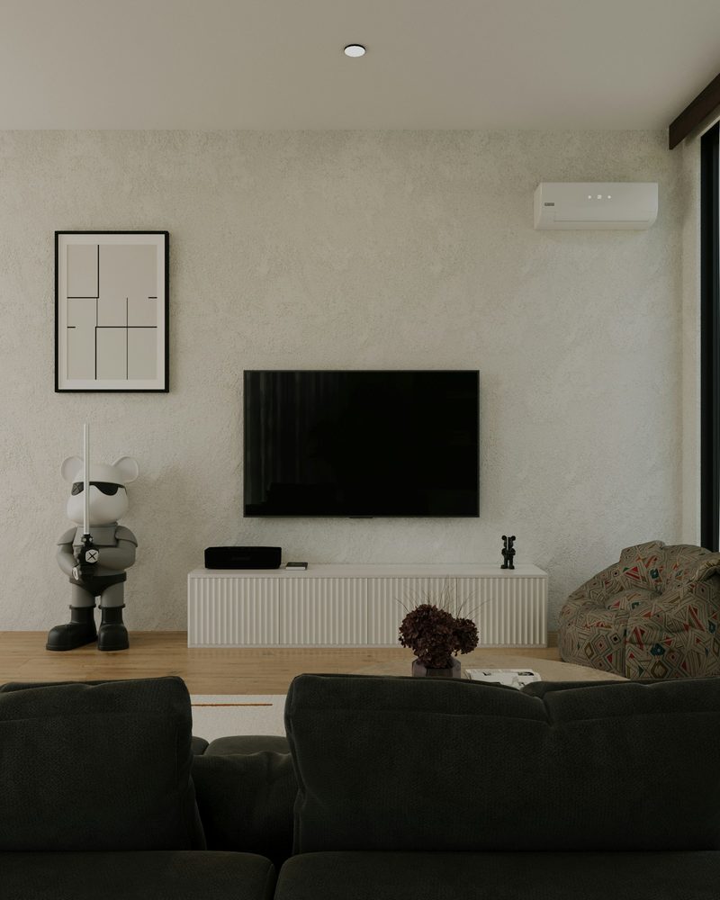Living room with a wall-mounted AC above the TV