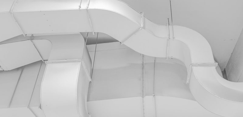 White ductwork running across a ceiling