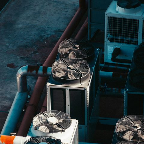 Cluster of outdoor condensing units and pipework on a rooftop